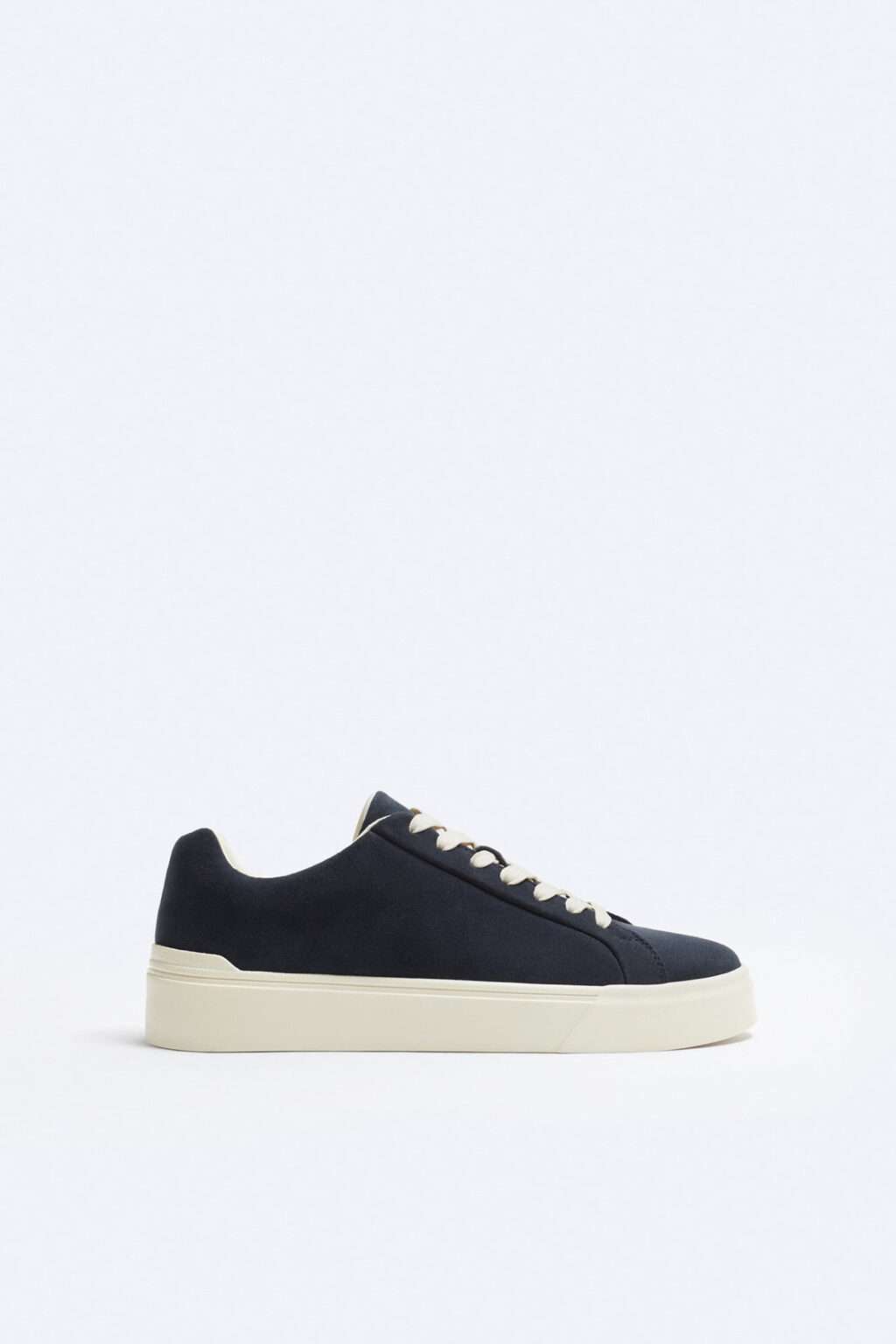 GROUND 01 navy nubuck low sneaker on pale background.